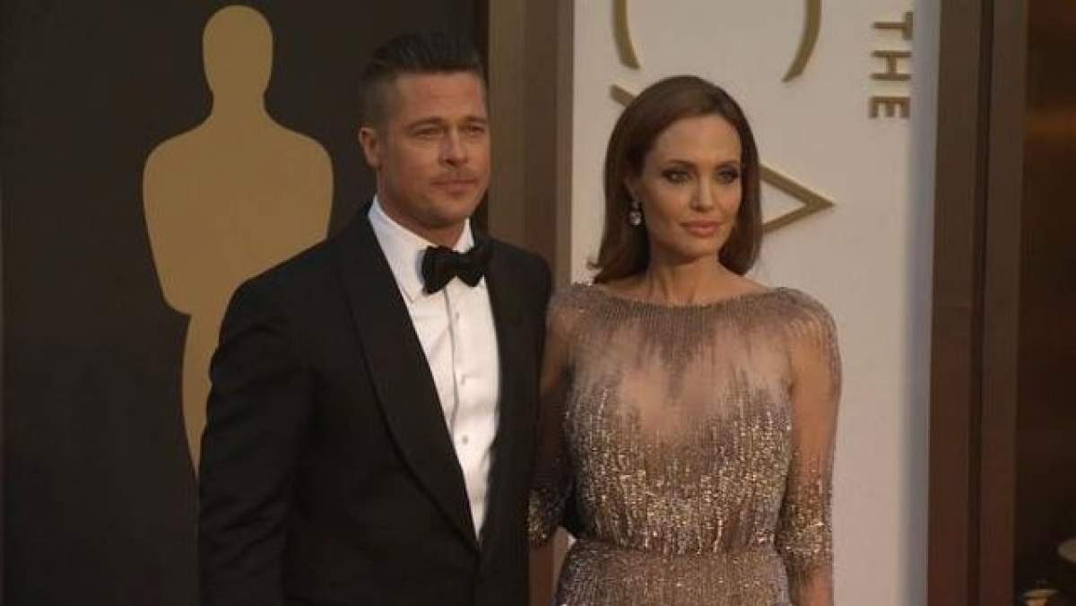 FOTO Nu credeai că o să-l vezi aşa vreodată! Îmbrăcat la patru ace la premiile Oscar, Brad Pitt muşcă cu poftă dintr-o felie de pizza, spre amuzamentul Angelinei Jolie