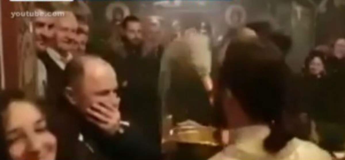 VIDEO / SCANDALOS! Un preot le-a făcut duş cu aghiazmă enoriaşilor, după ce i-a plesnit cu busuiocul peste faţă