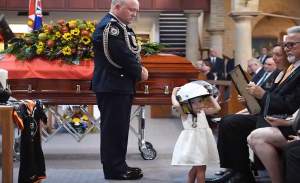 Imagini sfâșietoare! O fetiță se joacă lângă sicriul tatălui, un pompier mort în incendiile devastatoare din Australia. FOTO