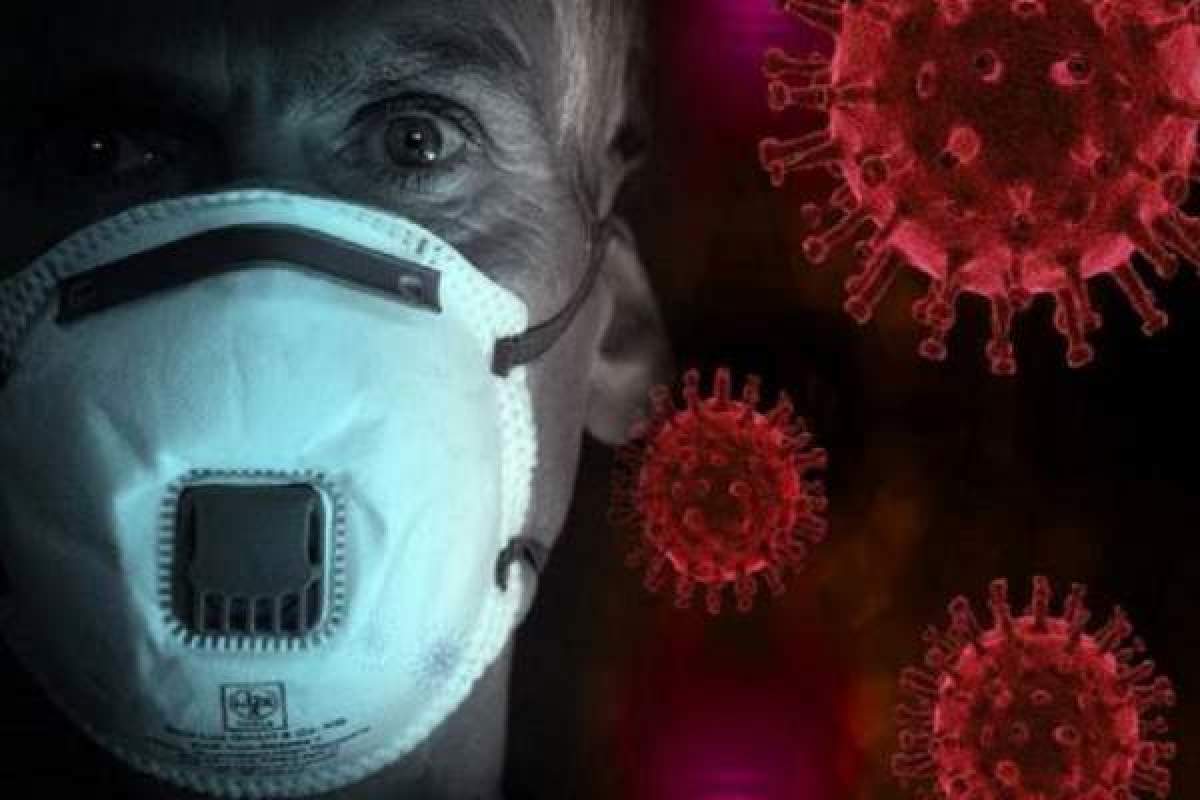 Fotografie cu indicatprul ce arată prezența coronavirusului și un bărbat ce poartă mască de protecție