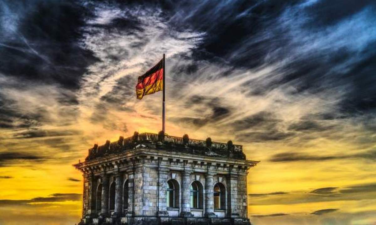 Fotografie cu o clădire din Germania și steagul țării