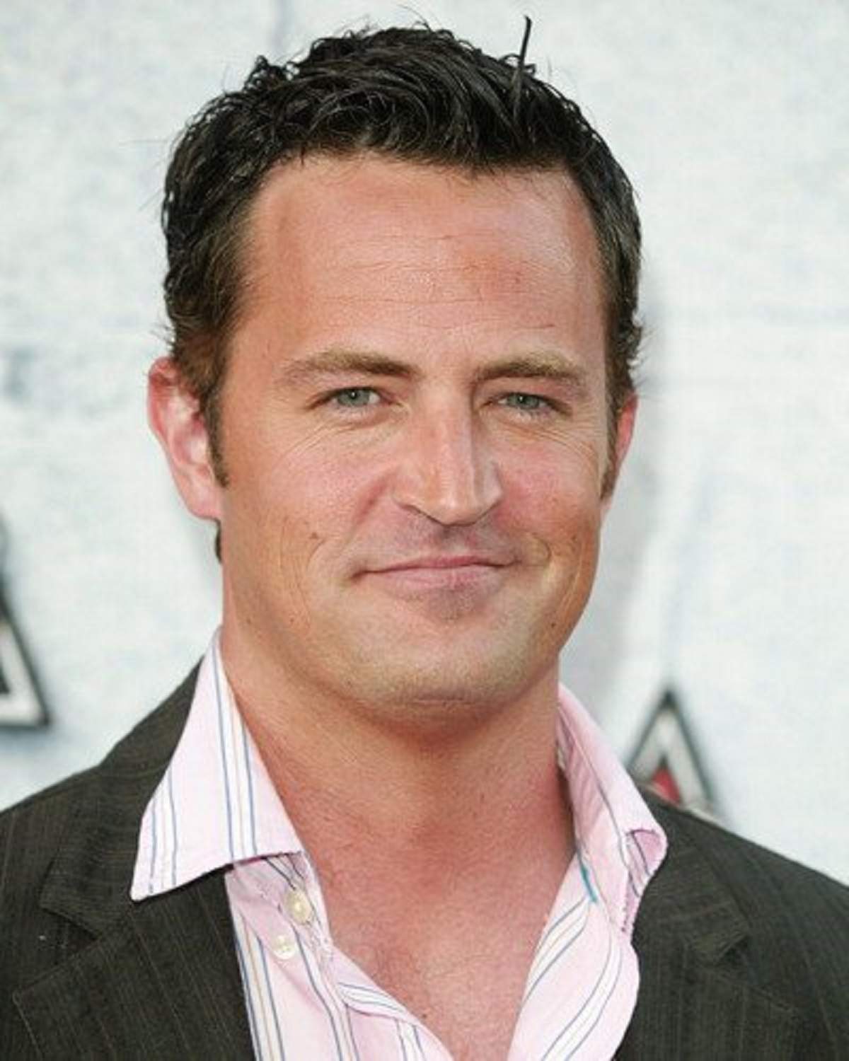 Matthew Perry este pe covorul rosu si poarta costum