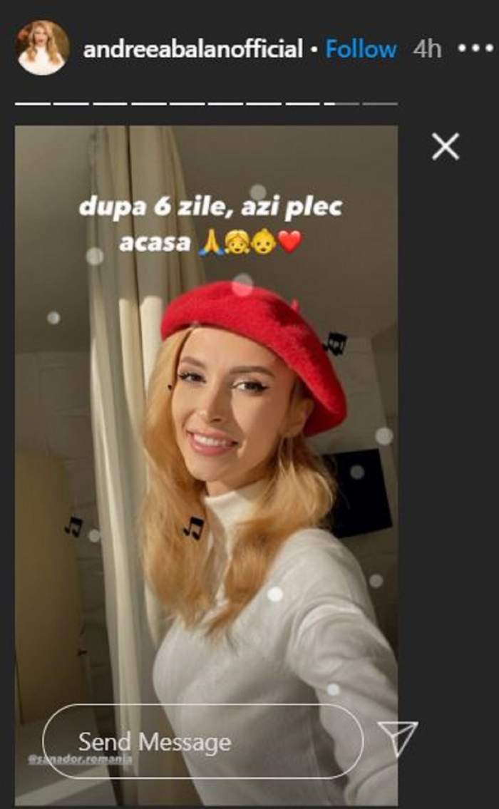 Andreea Balan poarta o boneta rosie si bluza alba