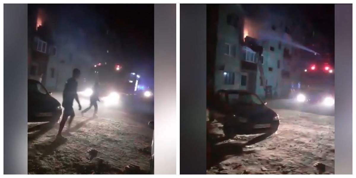 Pompierii sting incendiul din Băilești, Dolj. Niște vecini trec prin fața autospecialei