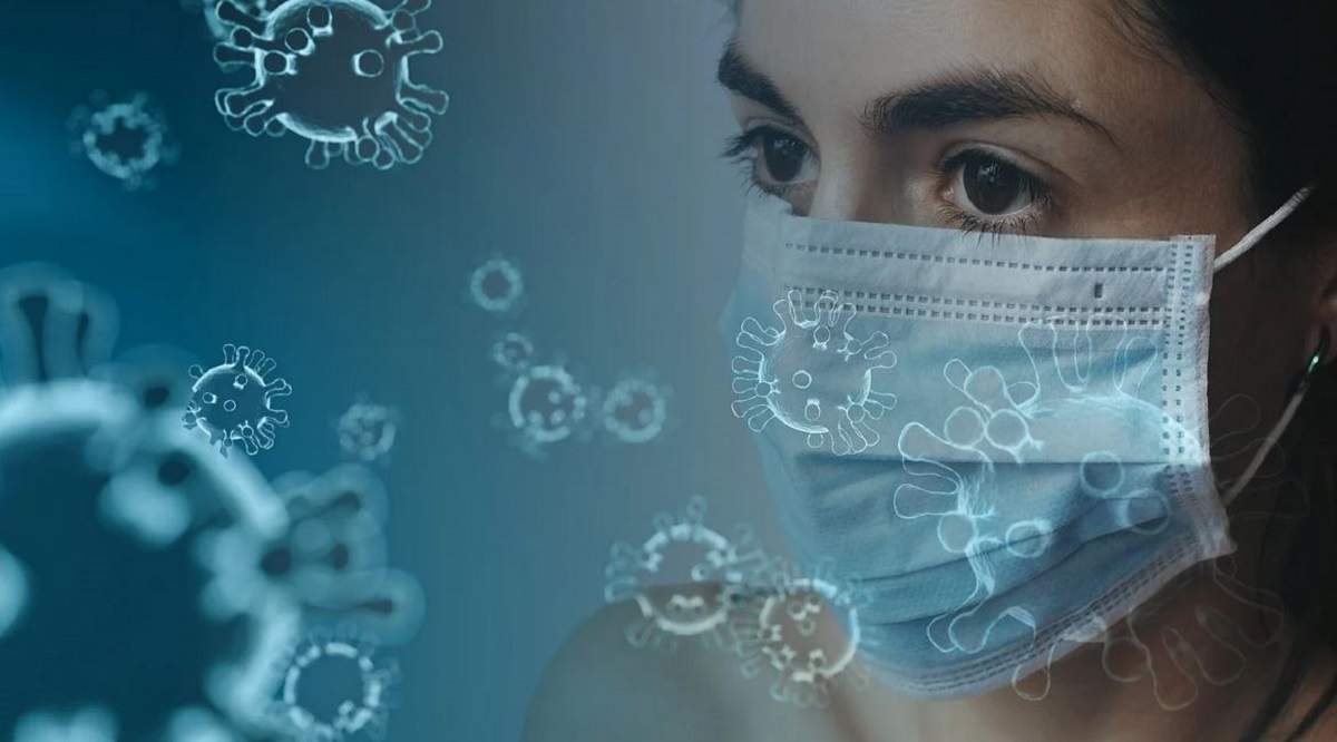 O imagine simbol pentru coronavirus. O fată poartă mască de protecție.