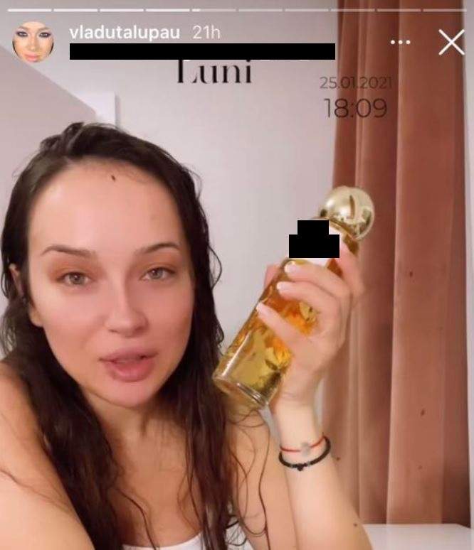 Vlăduța Lupău e nemachiată. Artista poartă un maiou alb și ține în mână un parfum.