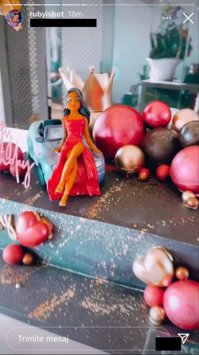 Tortul lui Ruby de ziua ei este negru, cu două etaje, ornat cu o figurină cu ea în rochie roșie, o mașină și multe inimioare și globuri colorate.