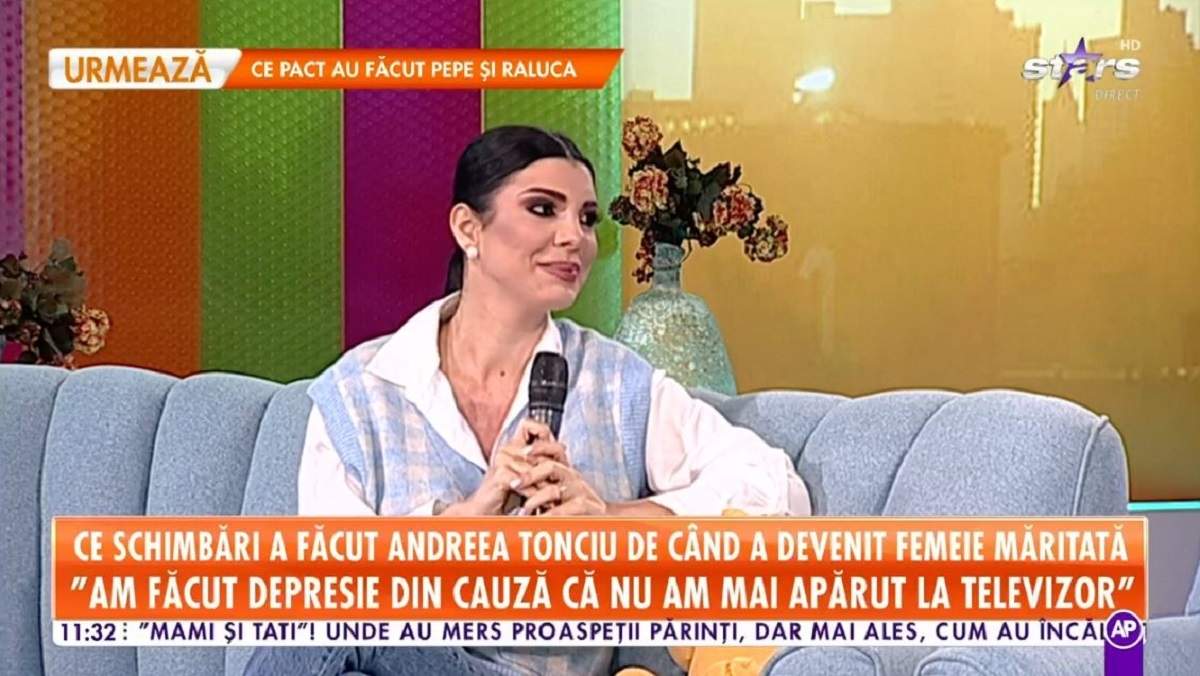 Andreea Tonciu se află pe canapeaua de la Star Matinal. Vedeta poartă o cămașă albă și un pulover albastru, în partea de jos niște blugi.