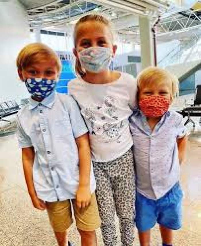 Trei elevi care poartă mască de protecție
