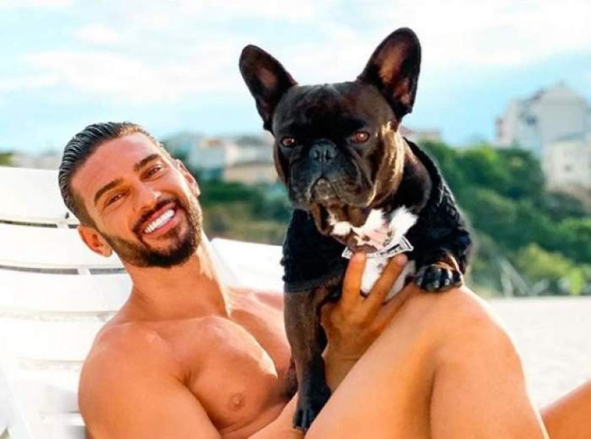 Dorian Popa cu câinele său în brațe.