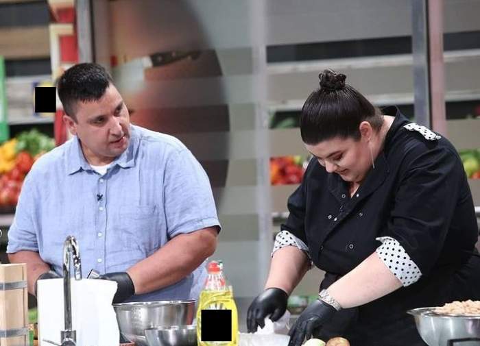 Claudia Radu și iubitul ei gătesc împreună la Chefi la cuțite. Ea poartă o uniformă neagră de bucătar, iar el o cămașă bleu cu mânecă scurtă.
