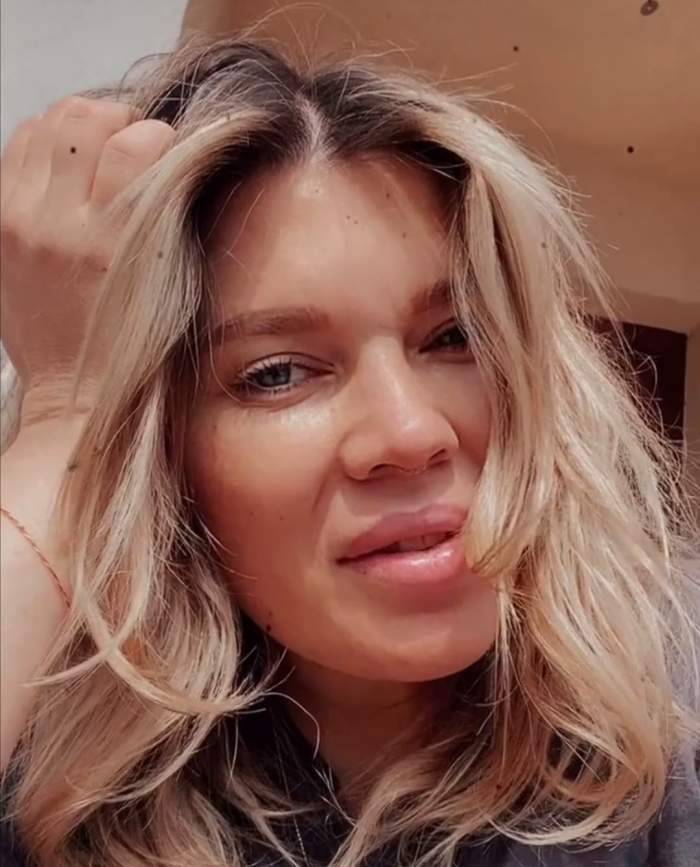 Gina Pistol, zâmbitoare, cu mâna în păr