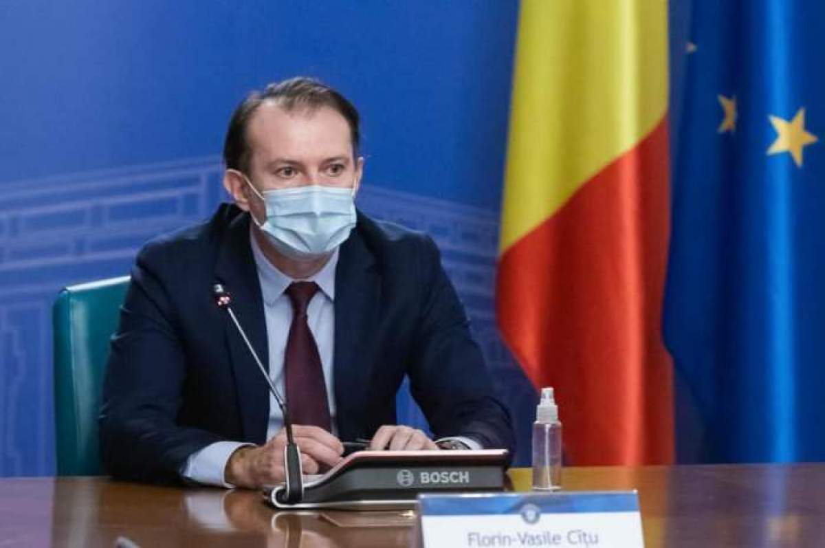 Florin Cîțu, în costum cu mască de protecție pe față, la ședință