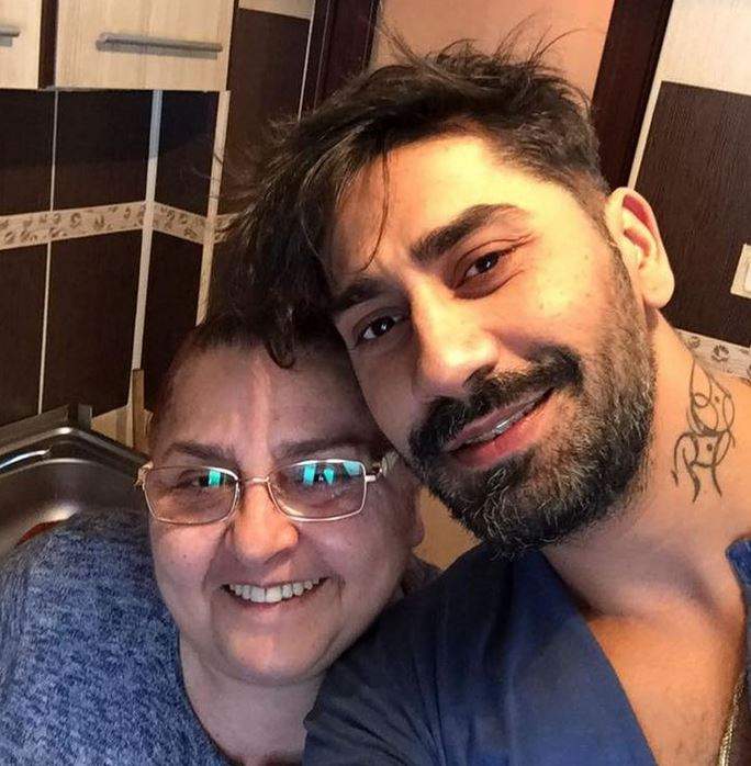 Connect-R și mama lui într-un selfie. Amândoi poartă bluze albastre și zâmbesc larg.