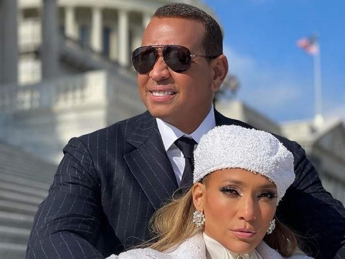 Alex Rodriguez și Jennifer Lopez sunt pe niște scări. El poartă cămașă albă, ochelari de soare și sacou negru, iar ea o beretă albă și o haină în aceeași nuanță.