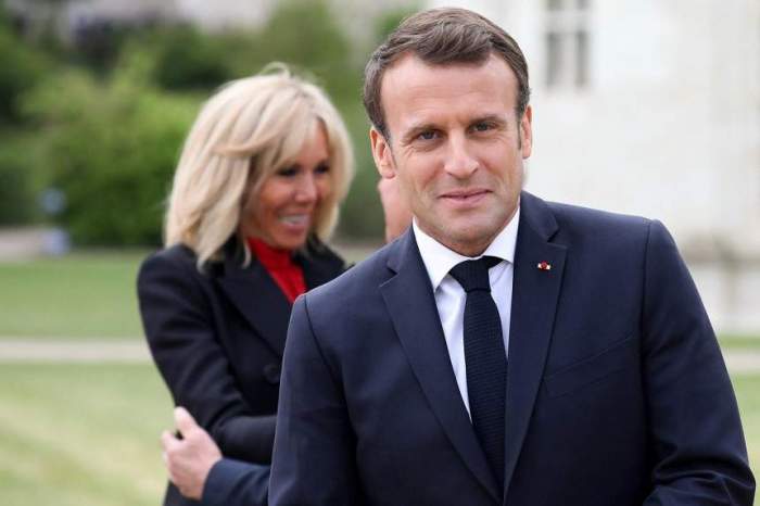Emmanuel Macron, zâmbitor, în fața soției sale