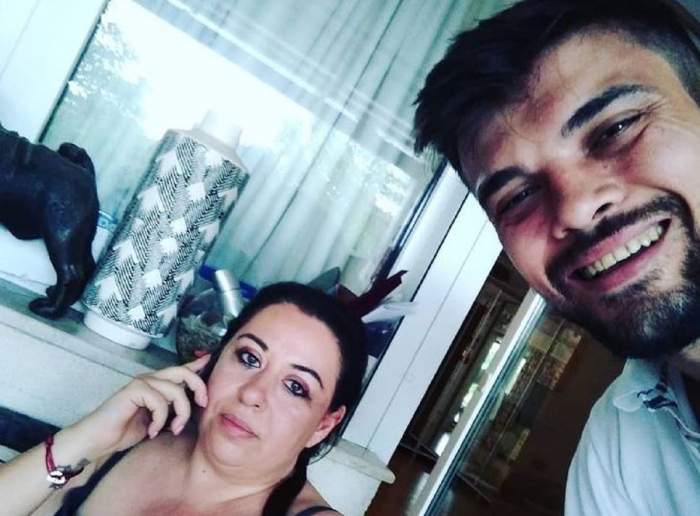 Oana Roman și Marius Elisei într-un selfie. Ea poartă un maiou negru și vorbește la telefon, iar el un tricou alb.