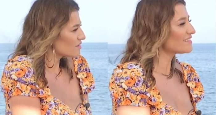 Claudia Pătrășcanu oferă un interviu de la mare pentru Antena Stars. Vedeta zâmbește și poartă o bluză colorată.