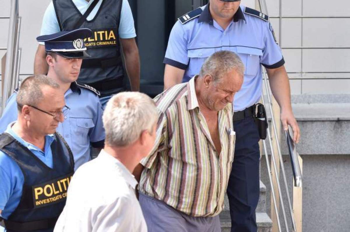 Gheorghe Dincă, escortat de polițiști din tribunal