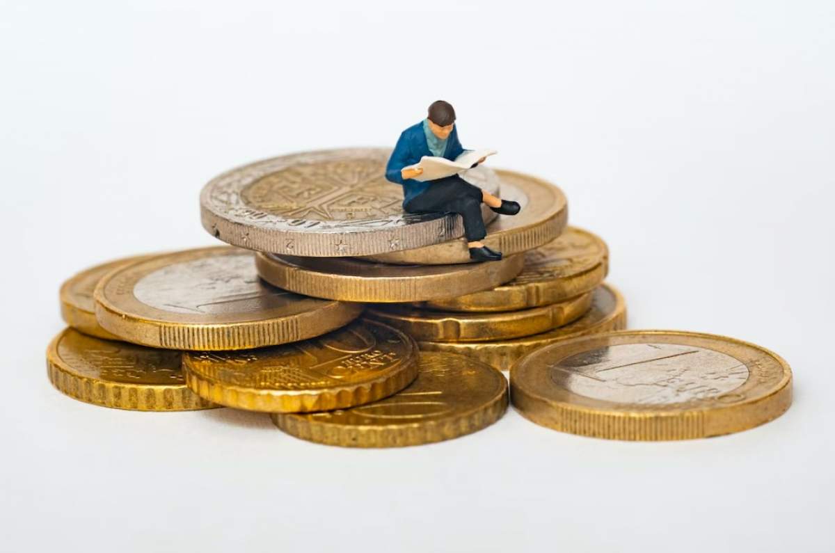 imagine cu un omuleț care stă pe monede de euro cenți