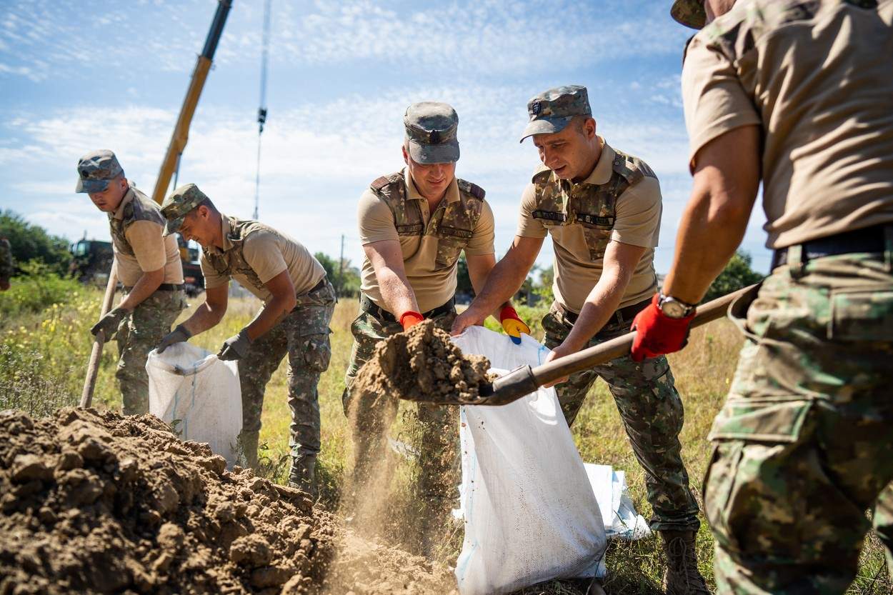 militari care construiesc adăposturi pentru oamenii care locuiesc în zonele unde cad drone