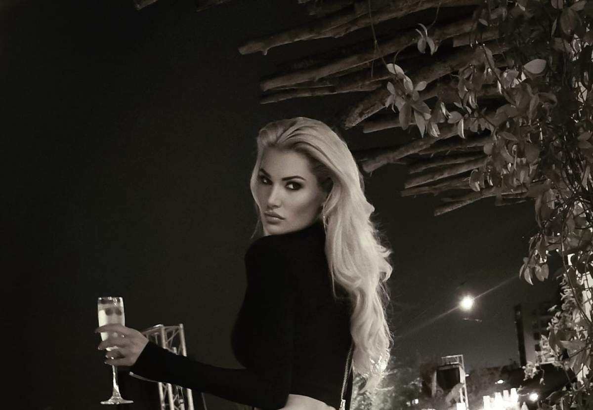 Tatăl copilului Emiliei Mușală nu a venit la botez. Emilia Mușală  cu un pahar în mână.