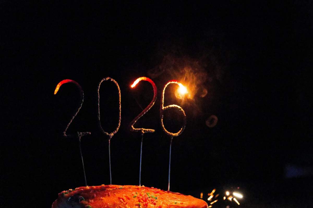 Prim-plan cu sclipici care se estompează formând anul 2026 pe un tort, simbolizând sfârșitul petrecerii de Revelion, trecerea la noul an, reflecția și un nou început