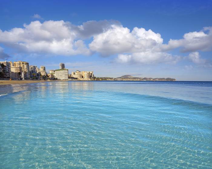 Plaja Playa de Fossa din Calpe și stânca Ifach Penon din Alicante în Spania