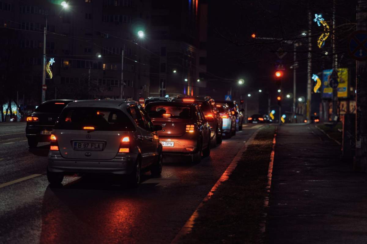 Scenă stradală urbană noaptea în București, România, cu lumini de mașină și drumuri goale ale orașului