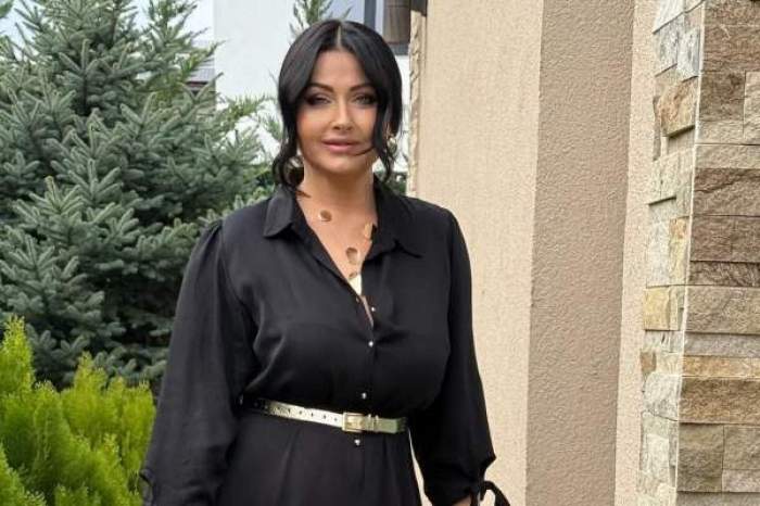 gabriela cristea afara, imbracata intr-o rochie neagra